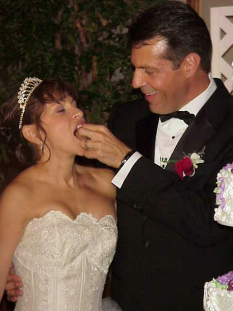 Randy feeding cake to Debra.
